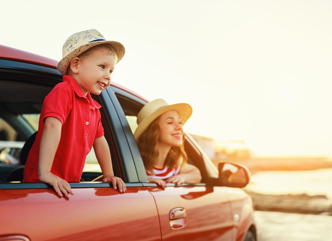 Personal Insurance - A Mother and Her Son Looking Out the Window at a Beautiful Sunset While in Their Car