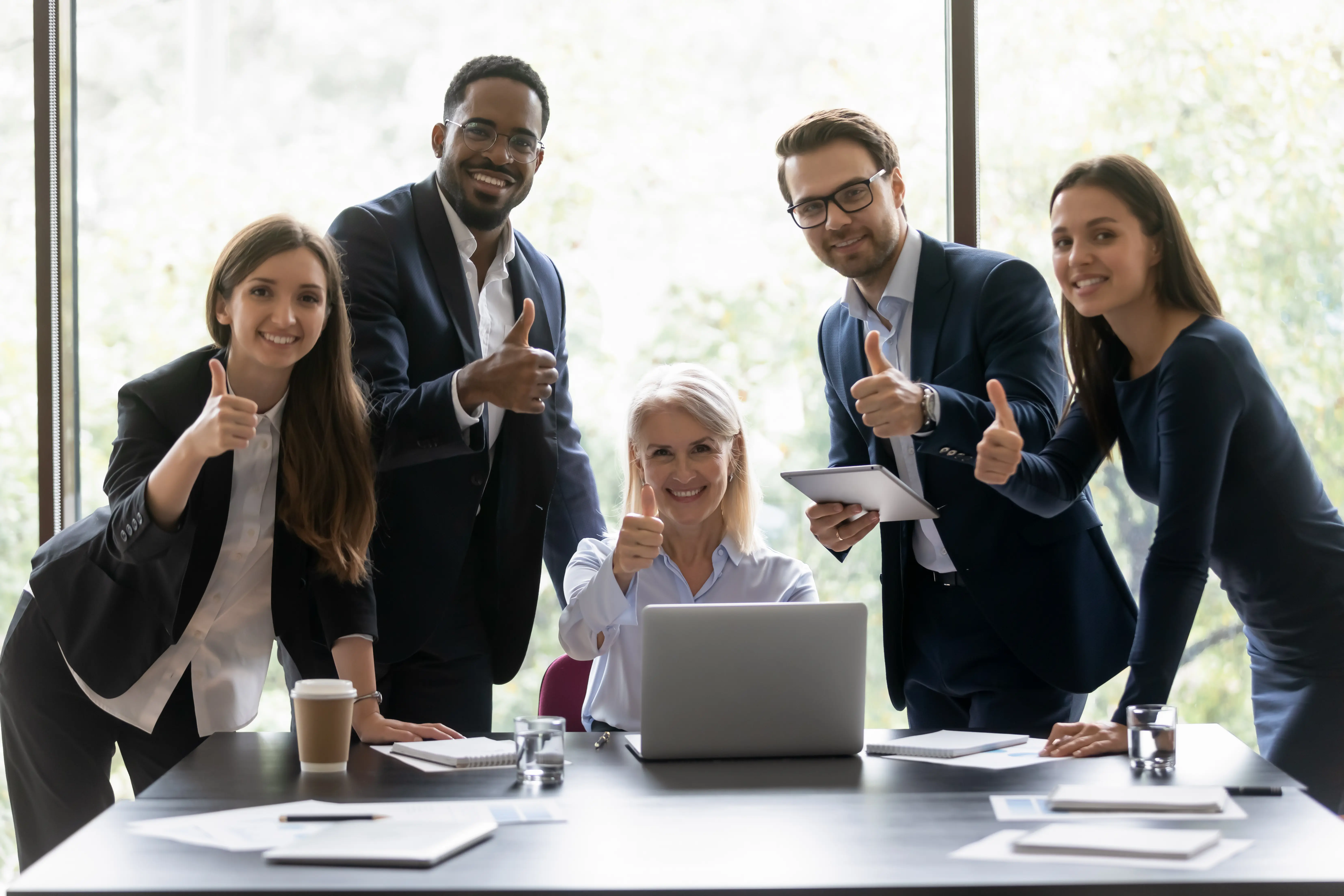 A group of consulting companies giving a thumbs up after acquiring consulting insurance